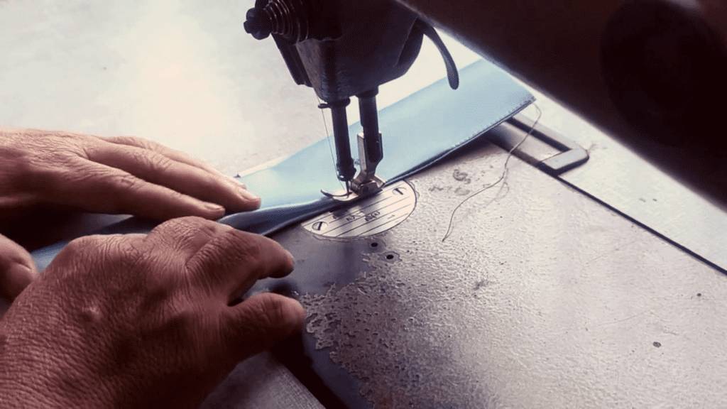 Seamstress in Thailand handmaking a Morph Bags product from event signage.