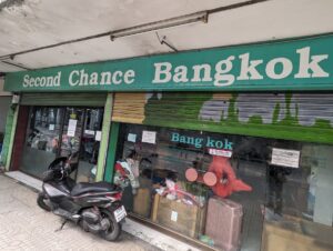 The entrance to Second Chance Bangkok with a variety of second hand items displayed inside.