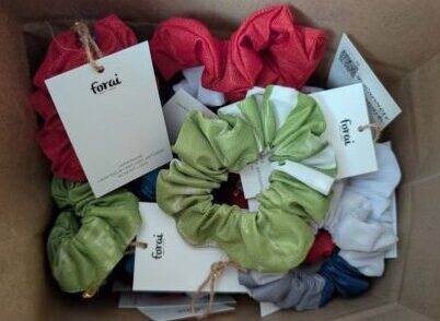 The scrunchies made by Forai for us each has a label signed by the refugee seamstress with their country of origin.