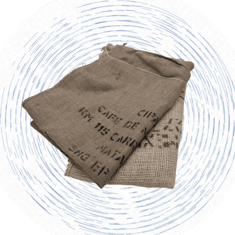 Two burlap coffee sacks are folded and stacked.