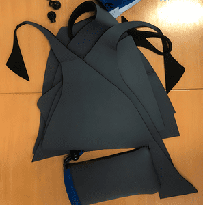 A pile of neoprene diving suit offcuts that Morph uses to make the sunglass case that sits next to them.