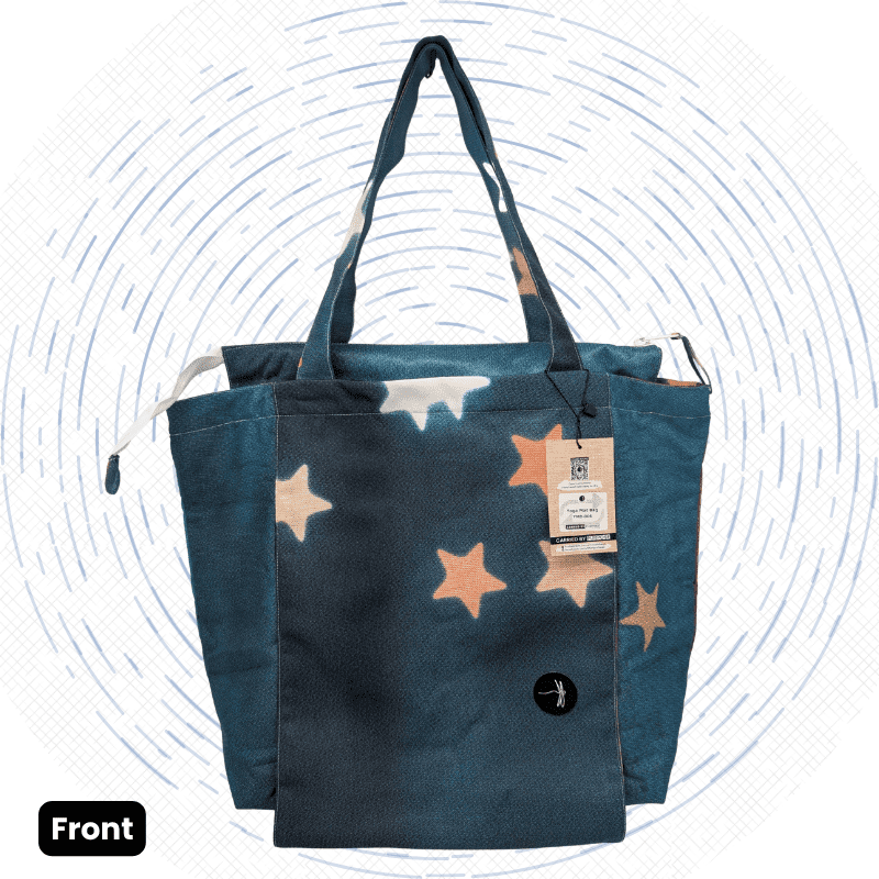 The front view of a one-of-a-kind dark blue-gray and black Morph Yoga Mat Bag with scattered peach and cream stars.