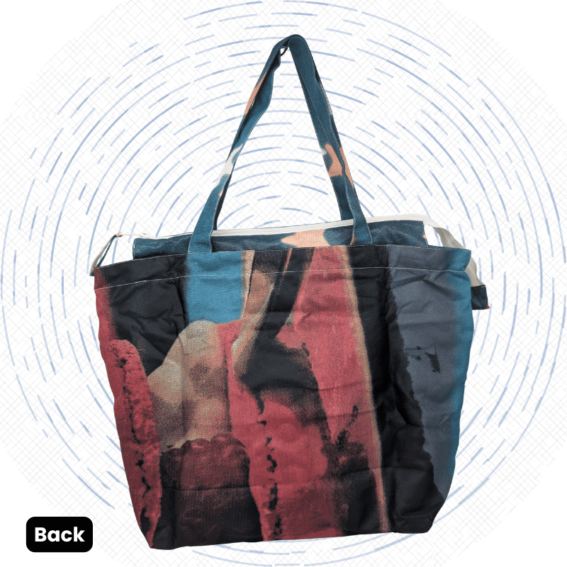 The back view of a dark blue-gray and black Morph Yoga Mat Bag with scattered peach and cream stars.