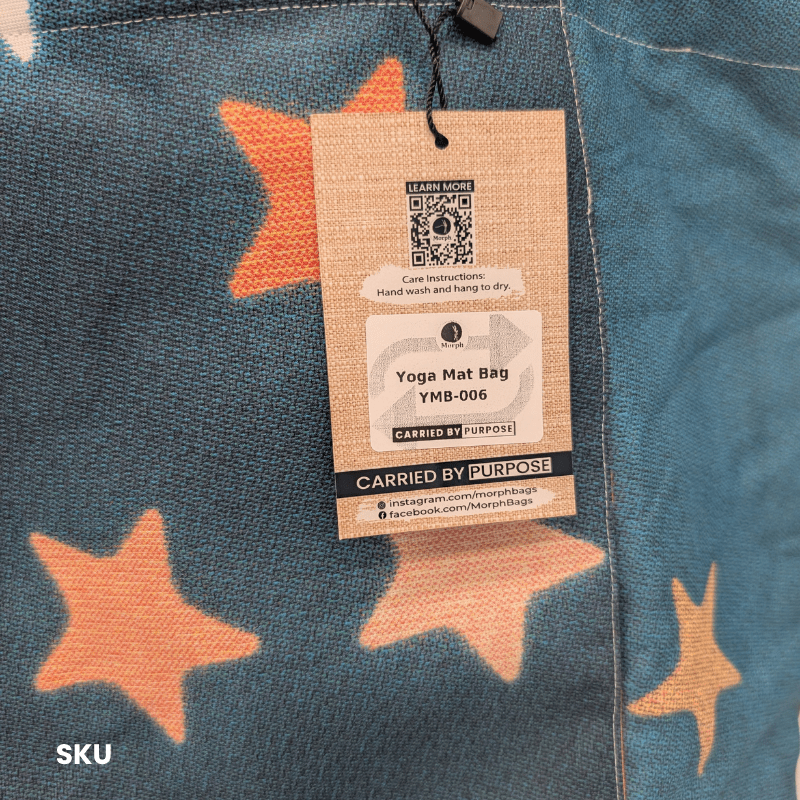 A closeup of the SKU of a dark blue-gray and black Morph Yoga Mat Bag with scattered peach and cream stars.