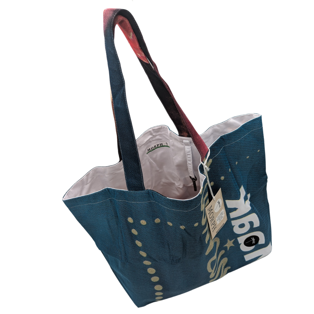 A dark green Large Morph Tote with Benefits with a white lining and the keyhook hanging inside,