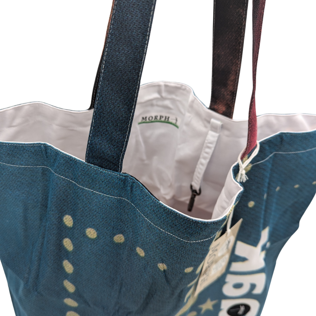 A dark green Large Morph Tote with Benefits with a white lining and the keyhook hanging inside,