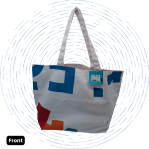 The front view of a one-of-a-kind white Large Morph Tote with abstract blue, red, orange, and teal geometric shapes.