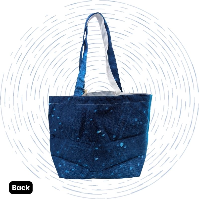 The back view of a tote featuring a distinct abstract art pattern in shades of blue and white.