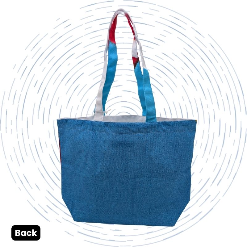 The back view of a white tote bag with bold red text and a brightly colored blue and red striped handle.