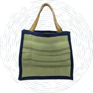 A large light green tote bag with dark blue trim and yellow handles made out of retired fire hoses.